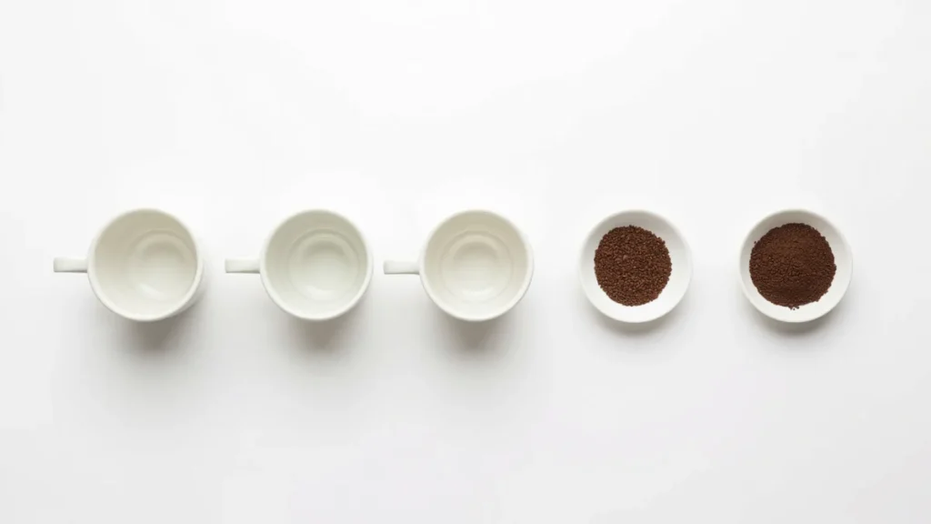 Five cups of increasing size with corresponding coffee doses showing how ratio scales with serving size